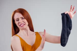 woman holding a dirty sock