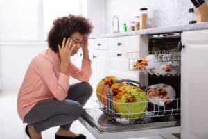 woman frustrated with her dishwasher